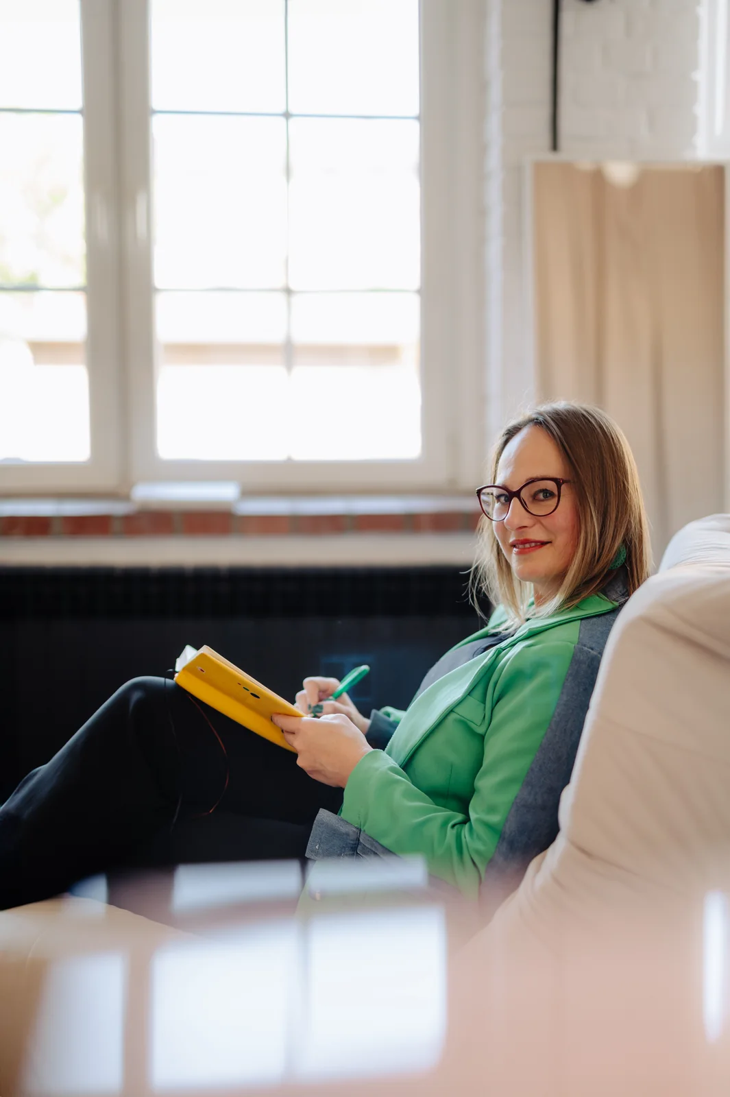 Anna G. seated with a notebook during a coaching session